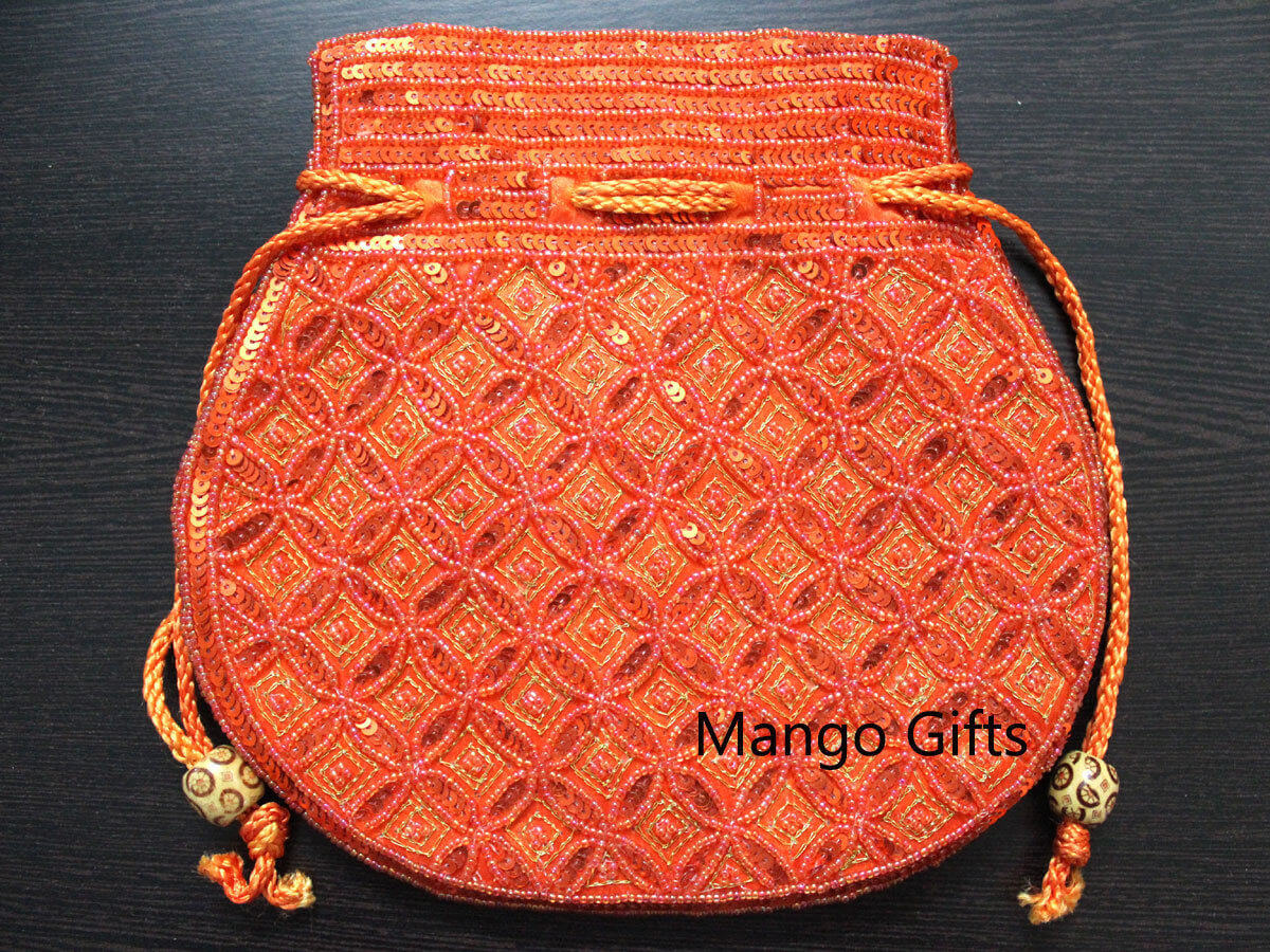 Beautiful handmade orange potli bag adorned with sequins, perfect for fashion and carrying small items.
